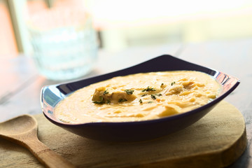 Thick yellow split pea soup with chicken and oregano