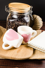 Two coffee cup on wooden board and coffee bottle with back backg