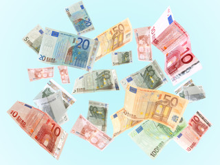 Flying Euro banknotes on blue background