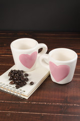 roasted coffee beans in coffee cup on wooden board with black  b