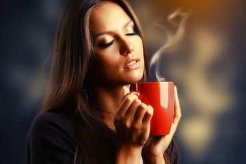 Beautiful young woman with cup of coffee