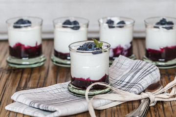 Yogurt with fresh blueberries and blueberries jam, in glass bowl