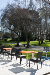 View of a coffee terrace in the garden with tables and chairs