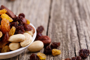 Mixed nuts on a white plate.