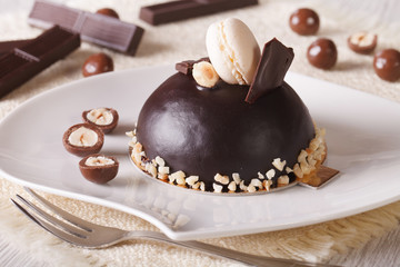 chocolate cake with hazelnuts, decorated macaroon horizontal