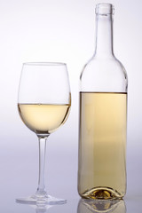 Wine bottle and glass with white wine