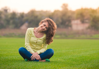 Fototapeta premium Beautiful girl smiling happy looking at camera in lotus pose