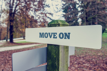 Move on concept with a rural signboard in an autumn landscape