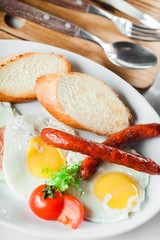 Breakfast. English breakfast with fried eggs, bacon, sausages