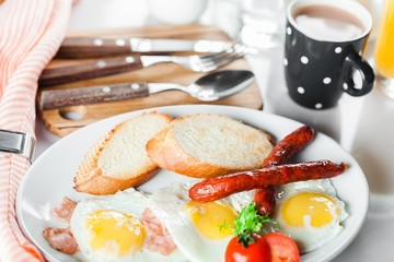 Breakfast. English breakfast with fried eggs, bacon, sausages