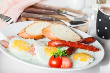 Breakfast. English breakfast with fried eggs, bacon, sausages