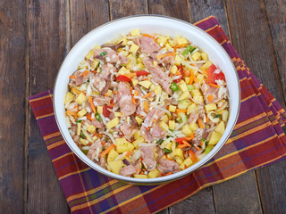 Raw meat with vegetables in a pan, stew