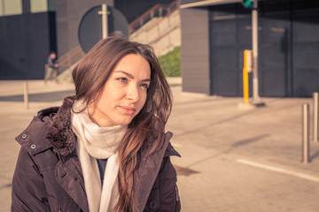 Fototapeta premium Young beautiful girl posing in the city streets
