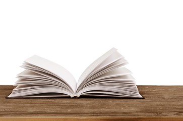Abstract. Open book on table in front of spring background