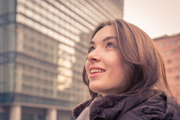 Young beautiful girl posing in the city streets