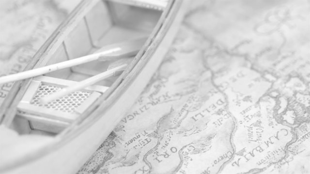 A white canoe boat on the map