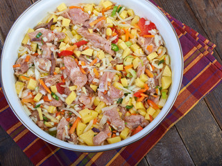 Raw meat with vegetables in a pan, stew