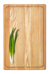 Fresh green onion on wooden board. Isolated on white background
