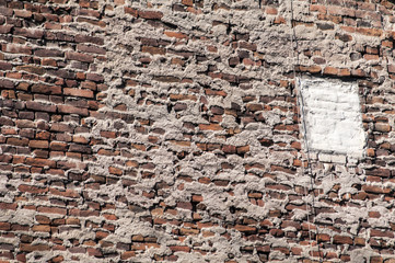 Old grunge not plastered brick house wall as background