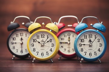 Clock. Retro alarm clocks on a table. Photo in retro color image