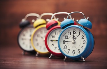 Clock. Retro alarm clocks on a table. Photo in retro color image