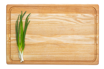 Fresh green onion on wooden board. Isolated on white background