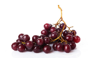Fresh red grapes and water drops isolated on white background