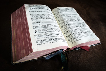 Fototapeta na wymiar Vintage psalm book with chorus singing notes