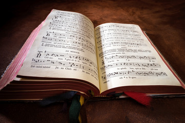 Vintage psalm book with chorus singing notes