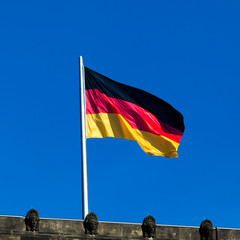 Silky flag of Germany flying in the wind.  German flag on the to