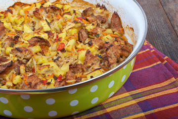 Meat with vegetables, stew on a wooden table