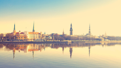 Riga center with reflection in Daugava, with retro filter effect