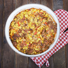 Meat with vegetables, stew on a wooden table