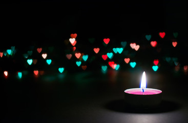candle on a black background with bokeh