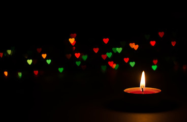 candle on a black background with bokeh