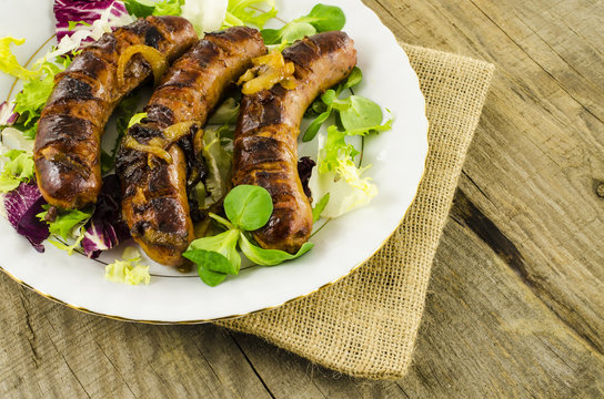 Roasted sausage on wooden table