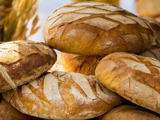 many brown rustic fresh rye bread loaves