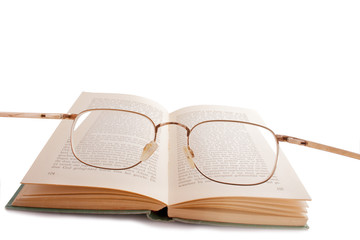 glasses on a book - Powered by Adobe