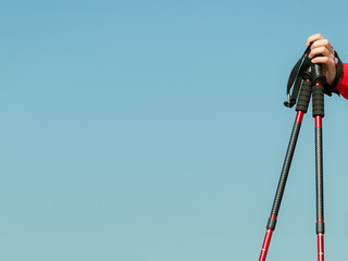 Nordic walking. Red sticks on blue sky background