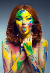 Funny woman with painted colorful body-art