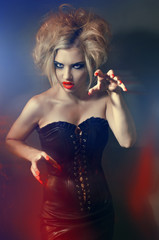 Portrait of young gothic girl with red lips and nails