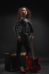 Sexy woman with red guitar