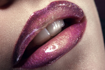 Closeup shot of woman lips with glitter