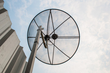 Satellite dish with sky background.