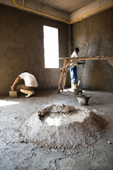 Worker pastering the wall