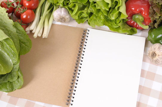 Summer Salad Lettuce Tomato Ingredients On Kitchen Worktop Counter With Open Blank Notebook Cookbook Or Recipe Book For Copy Photo