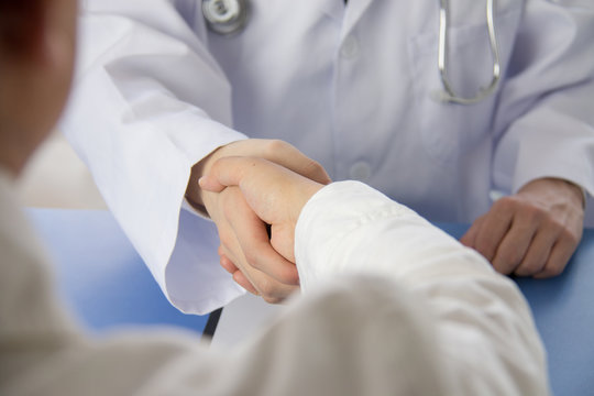 Doctor and businessman shaking hands