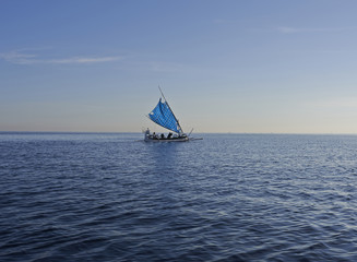 lonely sailing boat on ocean