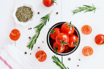 Ripe cherry tomatoes and spices on white background