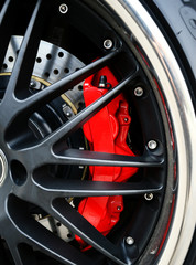 Fototapeta na wymiar Brake Disc and Red Calliper, Racing Car wheel close up
